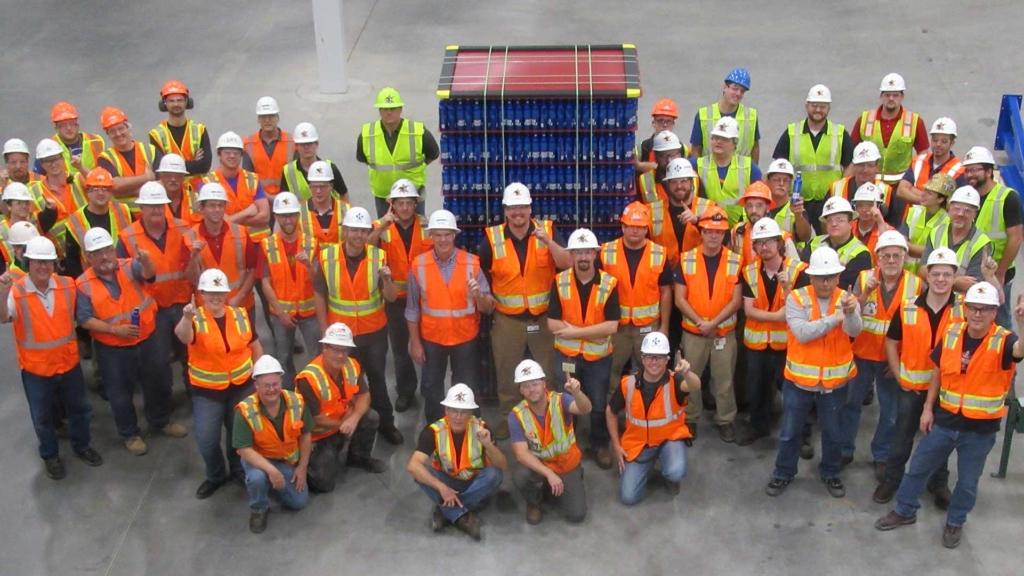 澳门足彩app employees posing with a pallet of beer.